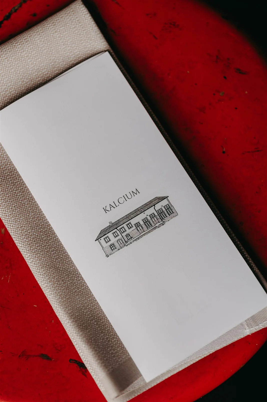 Kalcium’s menu with an illustration of the dairy on a red table